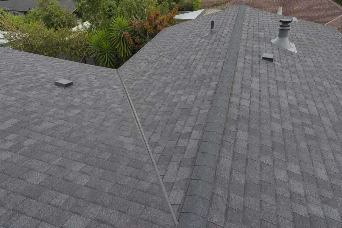 Architectural asphalt shingles across a finished sloped roof.