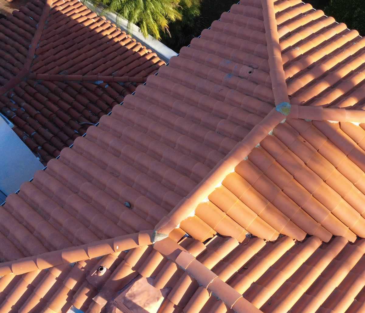 Aerial view of terracotta barrel-tile roof planes.